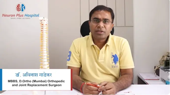 Dr. Avinash Gadekar, Orthopedic and Joint Replacement Surgeon at Neuron Plus Hospital, with a spine model.