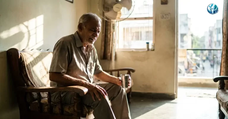Elderly Indian man experiencing sudden dehydration joint pain during the Ahilyanagar summer heatwave.